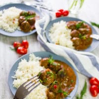 Three plates of Turkish Meatballs and one close up fork holding a meatballs