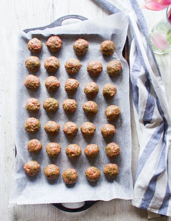 Raw meatballs shaped and ready to get sauteed in frying pan