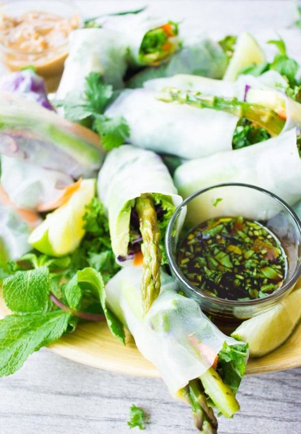 a plate of Summer Rolls with a small dish of chili cilantro dipping sauce on the side