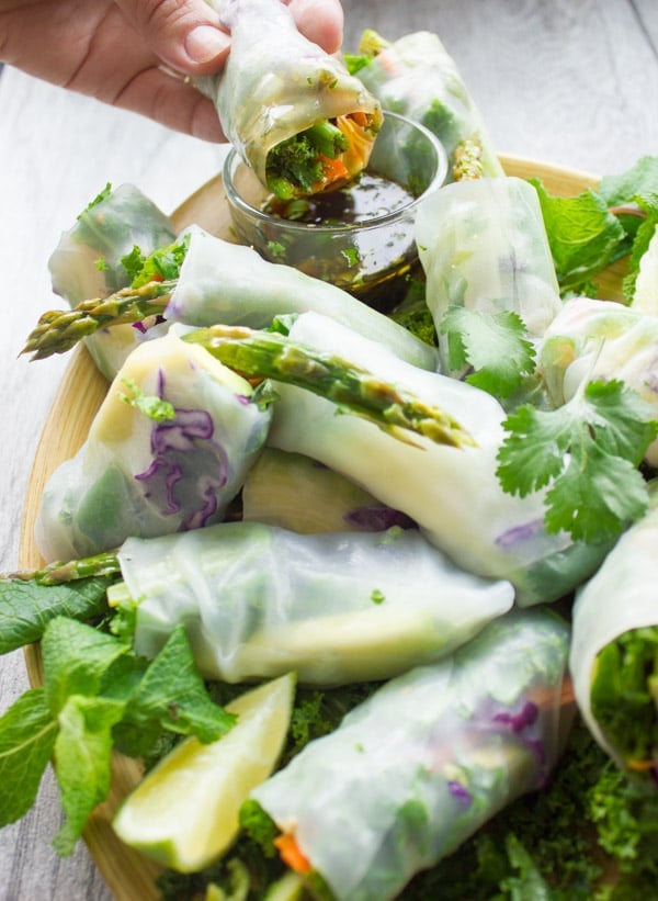 Summer Roll being dipped into a dish with cilantro dipping sauce