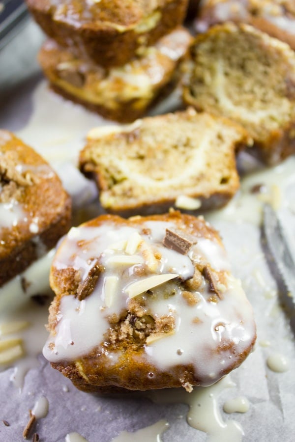 close-up of a glazed Cream Cheese Banana Bread Muffin on parchment paper