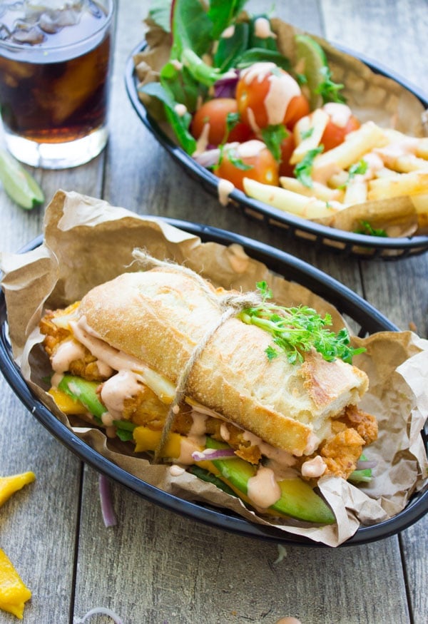 Spicy Sweet Sriracha Mango Chicken Sandwich on a plate with fries and a coke in the background