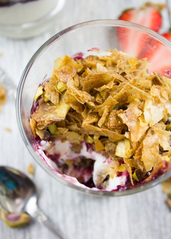 close-up of baklava yogurt parfait with one spoon missing