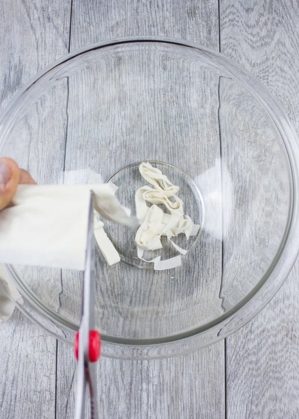 Filo Dough being cut into a glass bowl