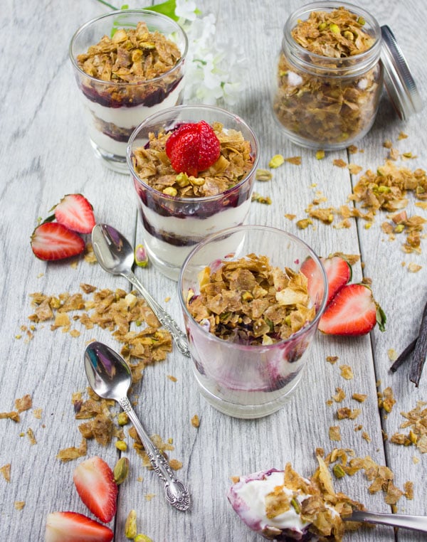 Baklava Yogurt Parfait with Homemade Baklava Crumbles served in glasses with fresh strawberries and some baklava crunch surrounding them