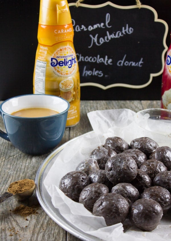 Caramel Spiked Chocolate Donut Holes. The best baked donut holes you'll ever make! tender, fluffy and intensely chocolate-y with a spike of caramel in the donut and glaze! Get the step by step recipe-www.twopurplefigs.com