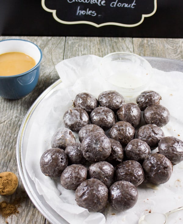 Caramel Spiked Chocolate Donut Holes. The best baked donut holes you'll ever make! tender, fluffy and intensely chocolate-y with a spike of caramel in the donut and glaze! Get the step by step recipe-www.twopurplefigs.com