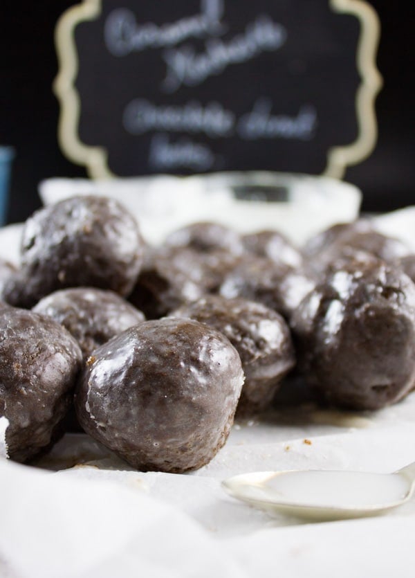 Caramel Spiked Chocolate Donut Holes. The best baked donut holes you'll ever make! tender, fluffy and intensely chocolate-y with a spike of caramel in the donut and glaze! Get the step by step recipe-www.twopurplefigs.com