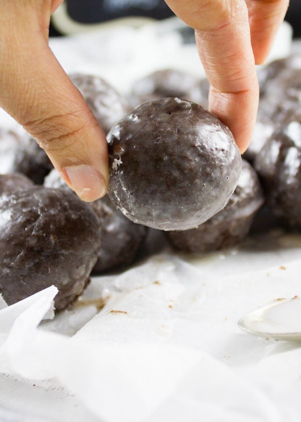 Caramel Spiked Chocolate Donut Holes. The best baked donut holes you'll ever make! tender, fluffy and intensely chocolate-y with a spike of caramel in the donut and glaze! Get the step by step recipe-www.twopurplefigs.com