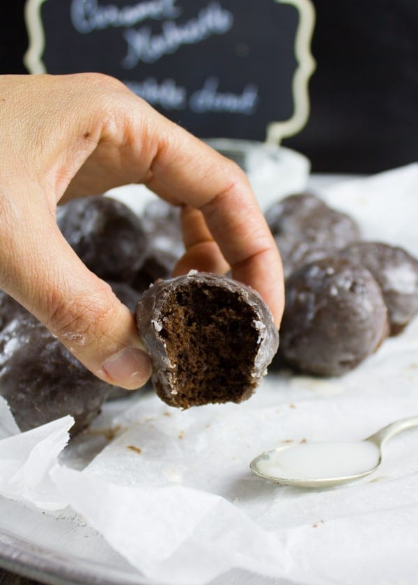 Caramel Spiked Chocolate Donut Holes. The best baked donut holes you'll ever make! tender, fluffy and intensely chocolate-y with a spike of caramel in the donut and glaze! Get the step by step recipe-www.twopurplefigs.com