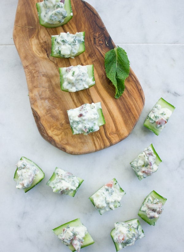 Feta Cucumber Salad Bites neatly arranged on a wooden board ready to be served as an appetizer