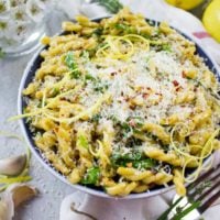 overhead shot of Garlic Lemon Pasta in a bowl topped with grated parmesan cheese