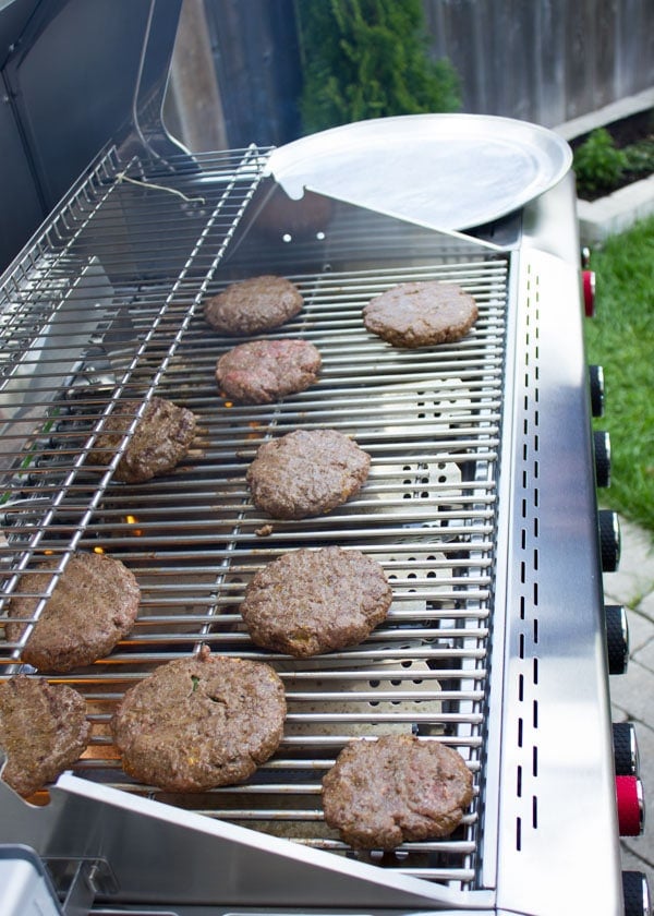 Juice Lamb Burgers grilling on a BBQ in the garden.