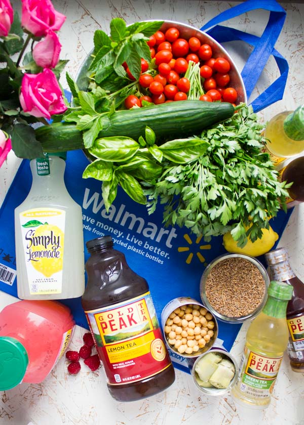 Ingredients for Mediterranean Farro Salad with Sweet Zesty Lemonade Dressing piled up on a Walmart bag.