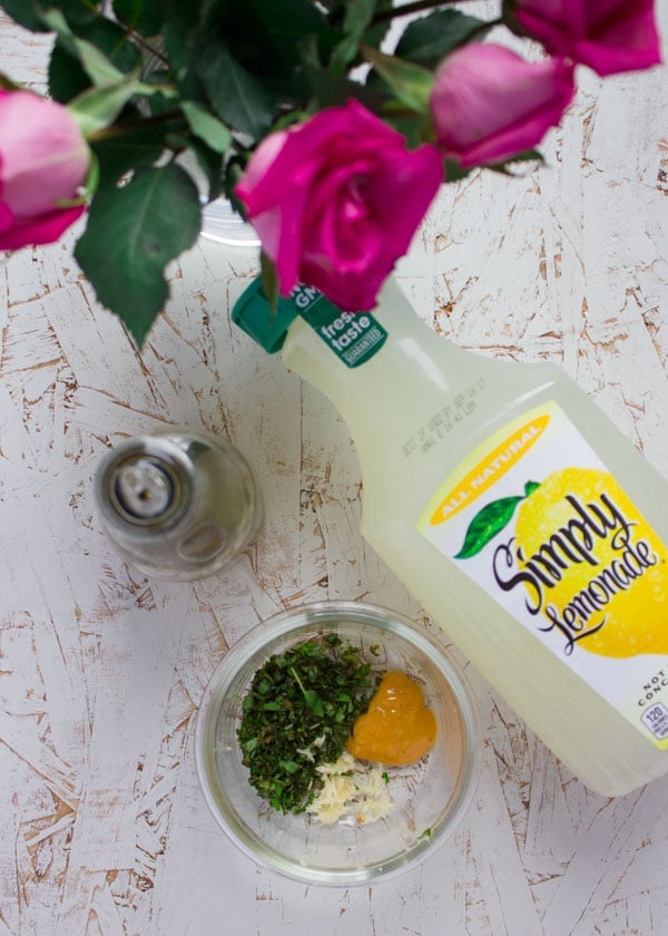 ingredients for lemonade dressing assembled on a white table.