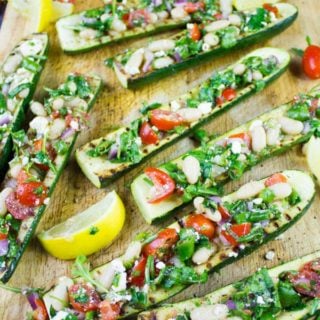 Zucchini Boats Grilled & Loaded With White Bean Salad. Even zucchini haters will love this--because it's all about the zesty bright Mediterranean filling! Easy, fresh, simple and utterly delicious way to use zucchini! Recipe at www.twopurpelfigs.com