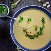 Creamy Peanut Soup with Peanut Crunch Herb Pistou. Authentic African recipe that my family picked up a long time ago, and we've been making/sharing it since then! It's pure peanut LOVE in every sip! www.twopurplefigs.com