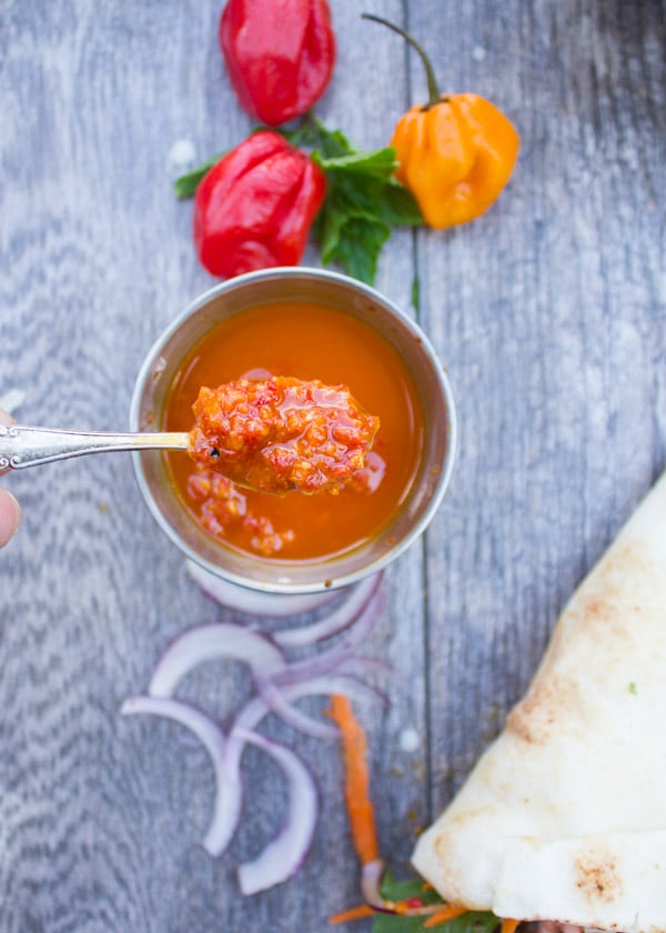 a small dish with homemade harissa on a rustic table.