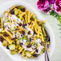 Holiday Turkish Pasta With Yogurt Sauce. This pasta dish is a HIT at every party because of the creamy, tangy and refreshing yogurt sauce! It's spiked with garlic, herbs, Brussel sprouts and sweet cranberries for the Holidays! Recipe and Video at www.twopurplefigs.com #ad #ChooseChickapea