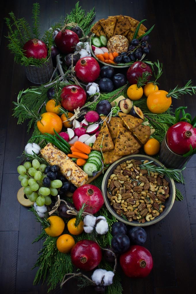 a festive display of winter fruit, Rosemary Spiced Candied Pecans and Pita Chips arranged for a Cheese Party