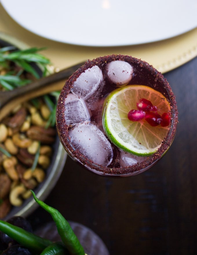 overhead shot of a glass of pomegranate mocktail with sumac dusted rim