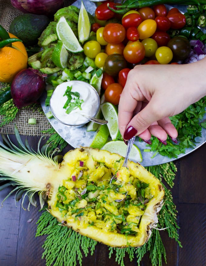 overhead shot of half a pineapple stuffed with fresh pineapple salsa