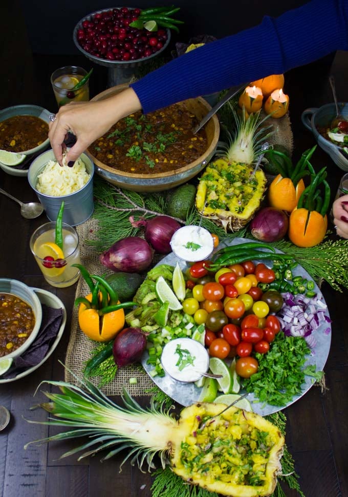 a chili bar with homemade vegetarian chili, pineapple salsa and a veggie platter