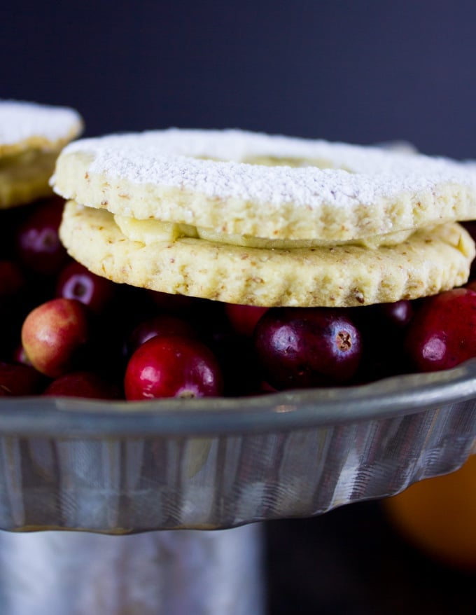 Holiday Maple Linzer Cookies. This delicious twist on a delicious cookie is the BEST! Bake a huge batch of these, they disappear fast! www.twopurplefigs.com