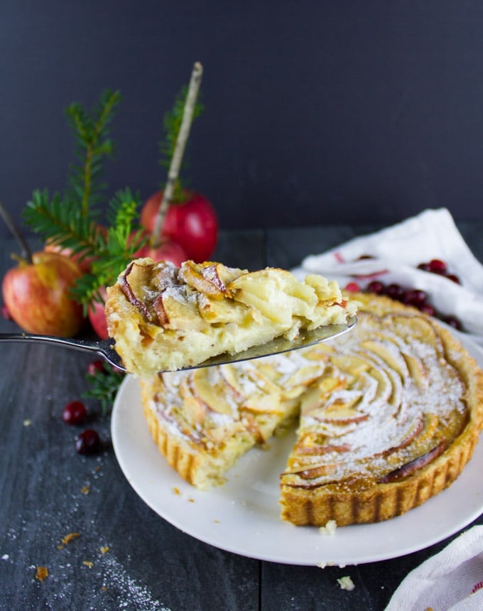 a slice of Swiss Apple Tart on a pie lifter