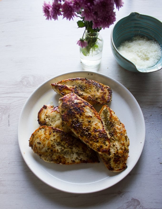 pan seared chicken breasts with a lovely golden crust on a white plate