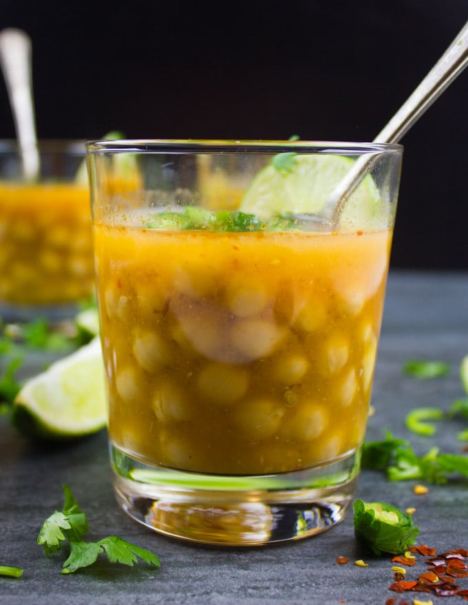 side view of a glass cup of Turkish chickpea soup