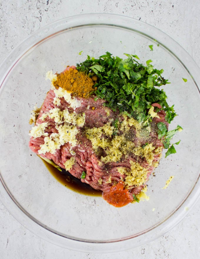 ground chicken being mixed with Thai herbs and spices