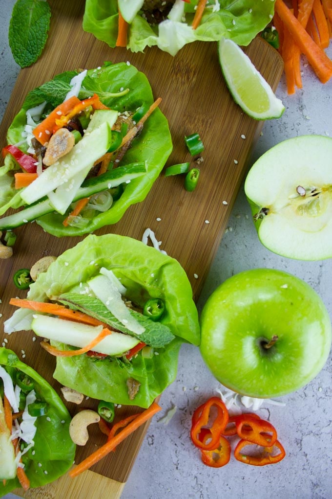 overhead shot of Thai Chicken Meatballs with Apple Peanut Sauce on a wooden board