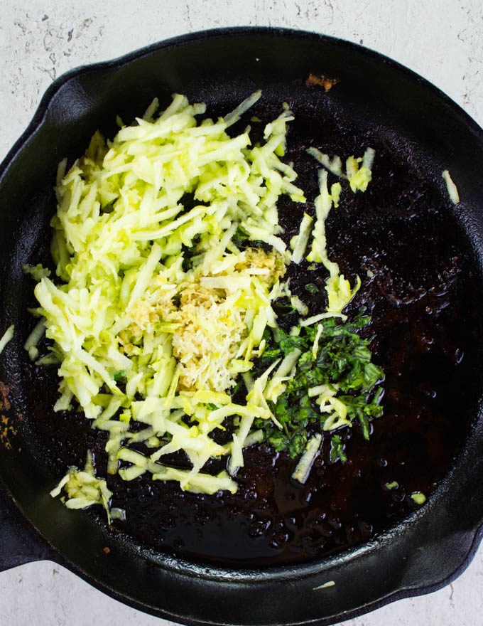 ginger being sauteed in a black skillet