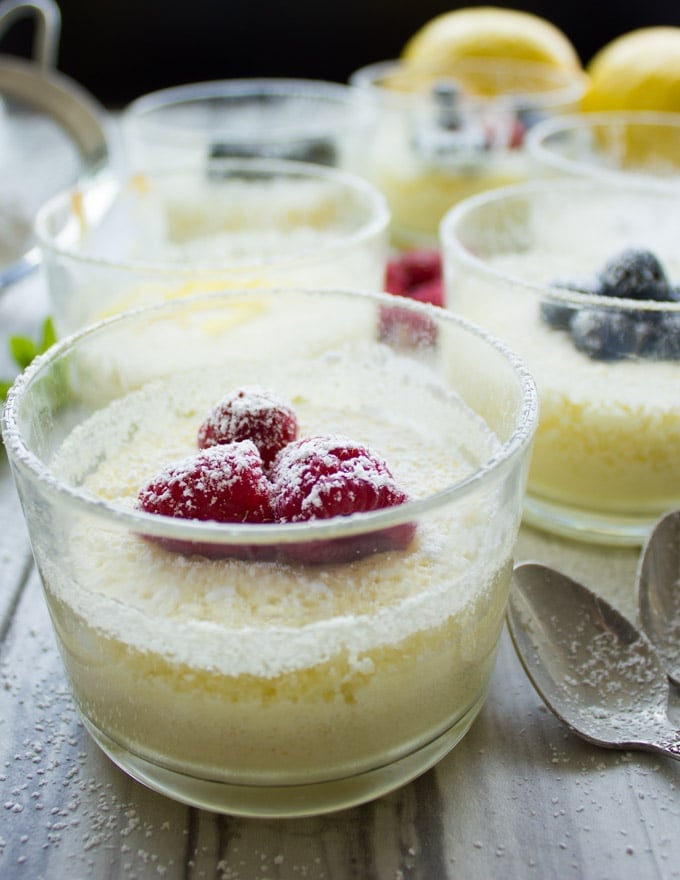 side view of an Easy Mini Lemon Pudding Cake topped with berries