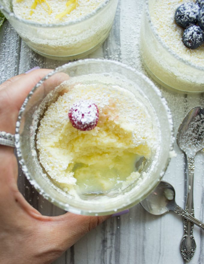 a half eaten Mini Lemon Pudding Cake in a small dessert glass