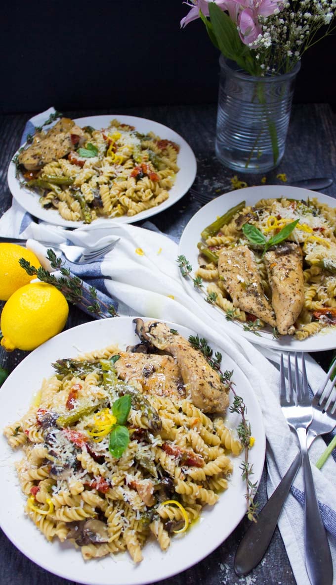 three plates of Quick One-Pot Creamy Chicken Pasta on a blue and white tablecloth