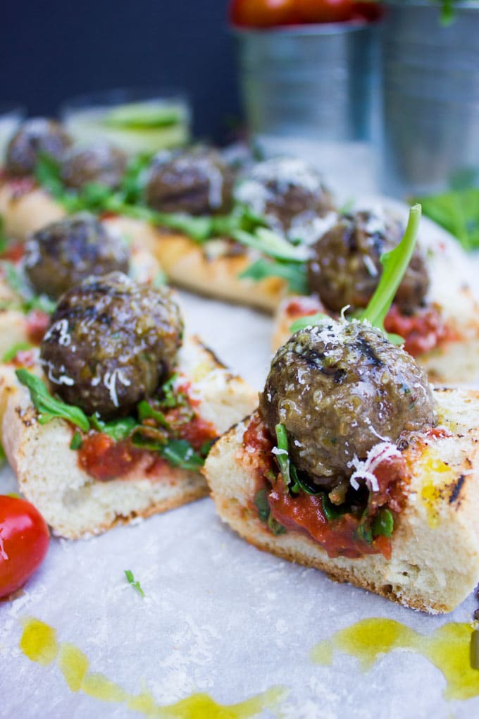 side view of pieces of American Lamb Meatball Sub with marinara sauce