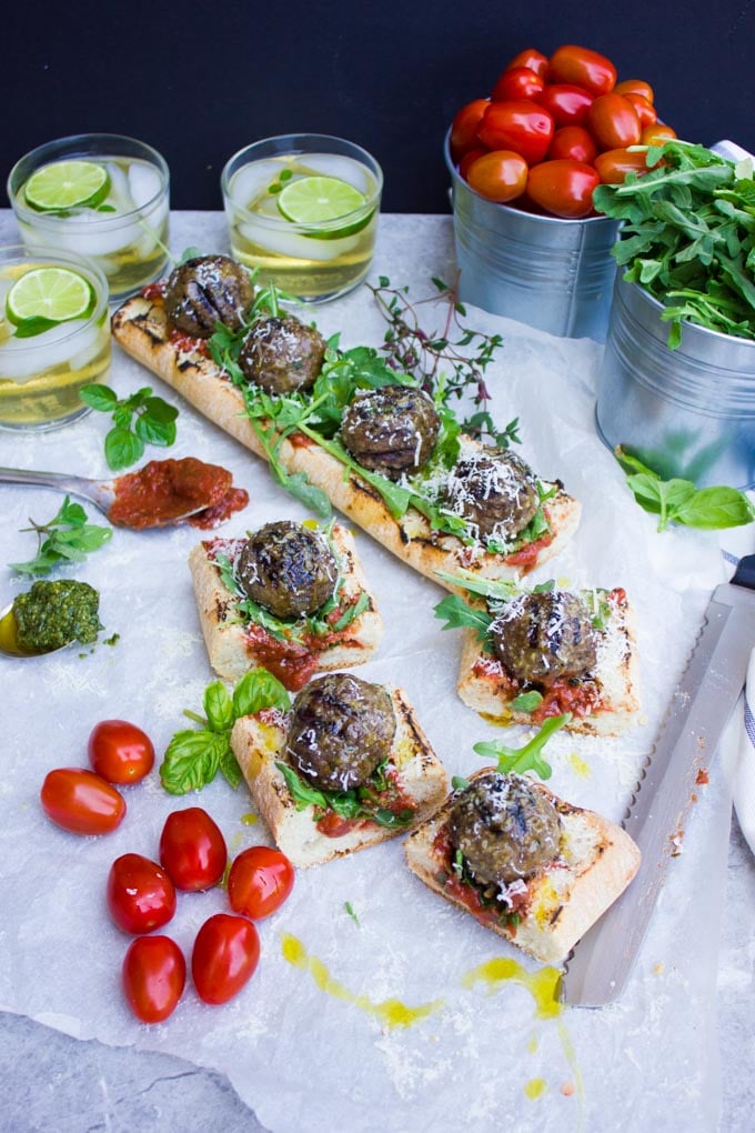 overhead shot of American Lamb Meatball Subs with marinara sauce and basil cut into pieces