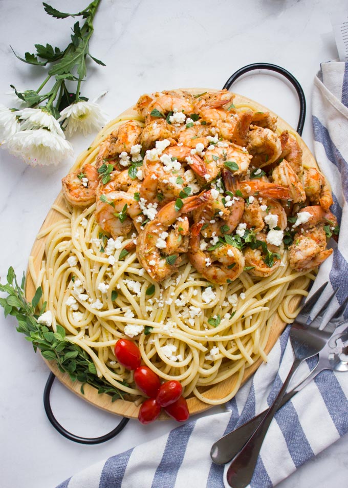 overhead shot of a platter of Quick Shrimp Pasta with Garlic Feta Sauce on a marble countertop