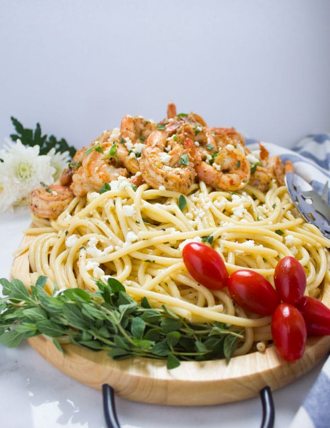 side-view of Quick Shrimp Pasta with Garlic Feta Sauce served on a wooden platter