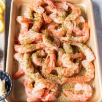 The shrimp is added to a sheet and tossed with the seasoning