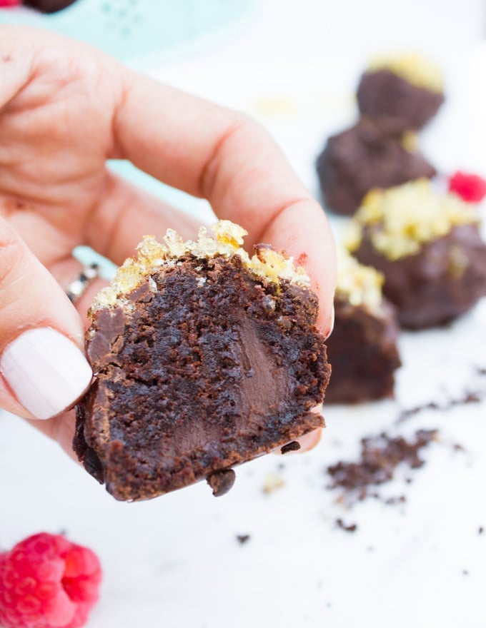 Chocolate Brownies Ball Dipped In Chocolate. Decadent fudgy brownies rolled and stuffed with a luscious chocolate truffle, then dipped in melted chooclate and topped with caramel bits. Need I say more!?