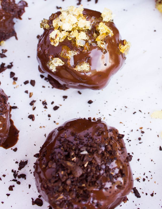 Chocolate Brownies Ball Dipped In Chocolate. Decadent fudgy brownies rolled and stuffed with a luscious chocolate truffle, then dipped in melted chooclate and topped with caramel bits. Need I say more!?