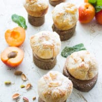 Individual Whole Apricot and Peach Pies on small round wooden stands
