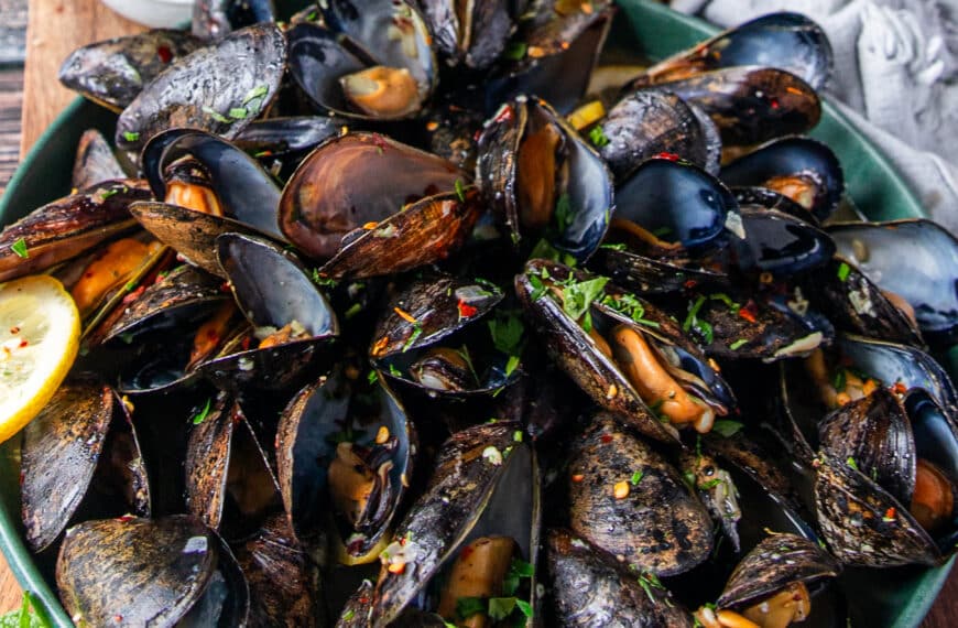 A large plate of perfectly cooked mussels