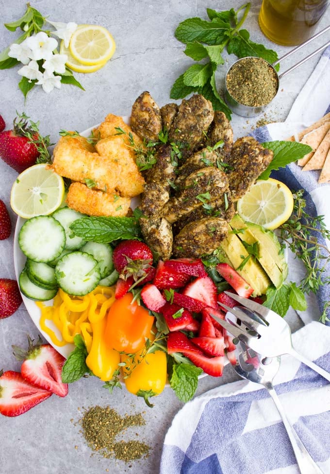 overhead shot of Zaatar Chicken Salad with Breaded Fried Halloumi Cheese and fresh fruit