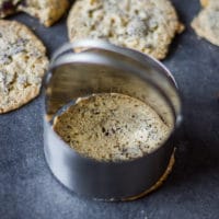 a cookie cutter trimming off the coffee cookies once baked to perfect round shape