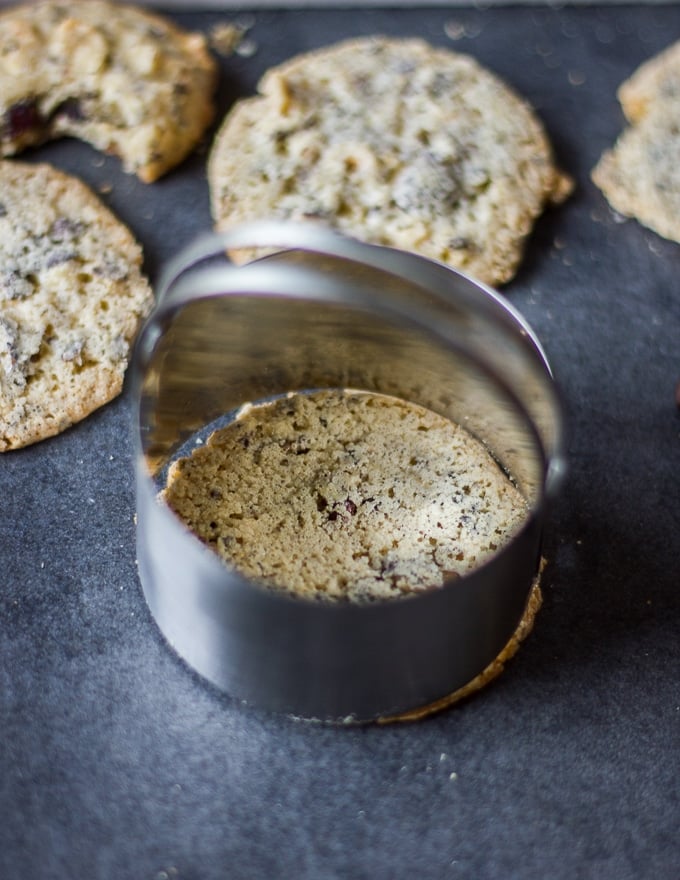 a cookie cutter trimming off the coffee cookies once baked to perfect round shape