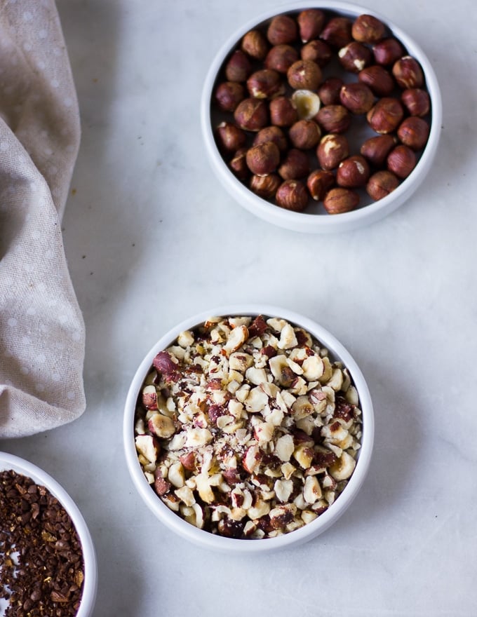 crushed hazelnuts on a plate to use in the coffee cookies